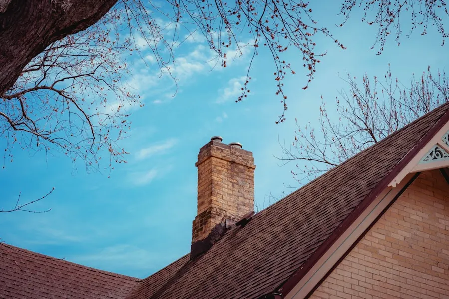 Brick chimney rising past a shingle roofline